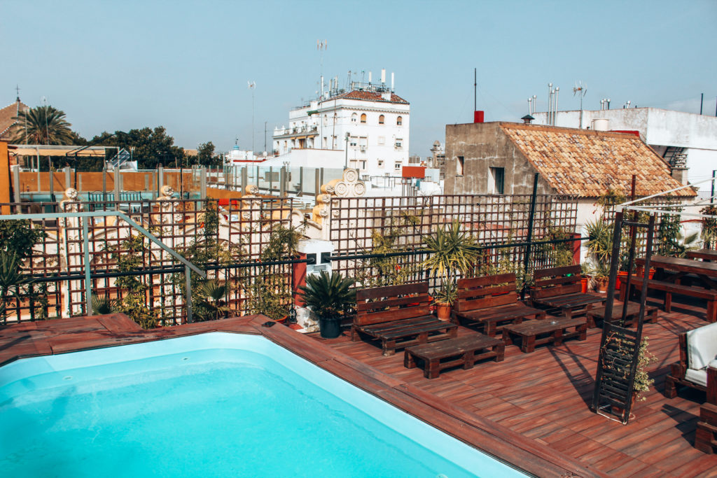 What to do in Seville: Stay at Oasis Backpackers Palace. Equipped with a rooftop, swimming pool, and lounge in the heart of the city.